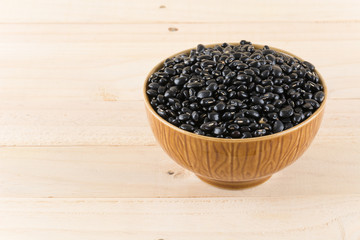 black beans on wood background