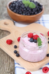 Yogurt and ripe blueberries and raspberries