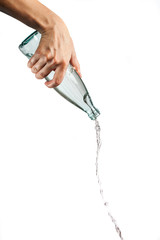 Hand pouring drinking water from glass bottle