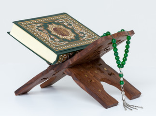 Quran with prayer beads on book stand