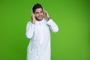 Young arab man listening to music on headphones