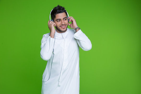 Young Arab Man Listening To Music On Headphones