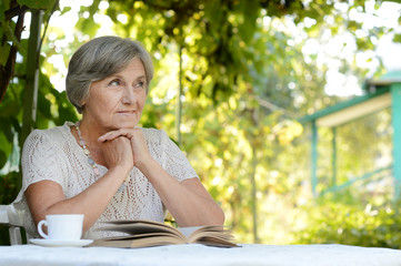 Middle-aged woman reading book