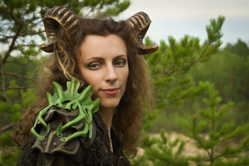 Portrait of the pretty female faun in a wood