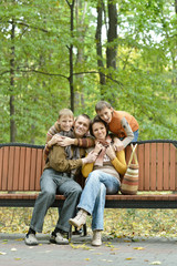  Family relaxing in autumn park