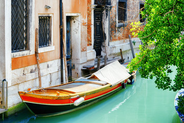 Fototapeta na wymiar Boat parked beside old house on Rio de S. Cassan Canal, Venice