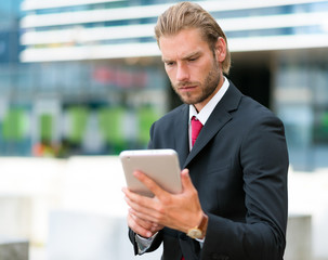 Businessman using his tablet