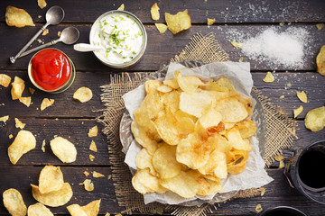 Potato chips with dipping sauces on a rustic table - 91319176