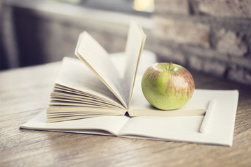 Book, diary and apple