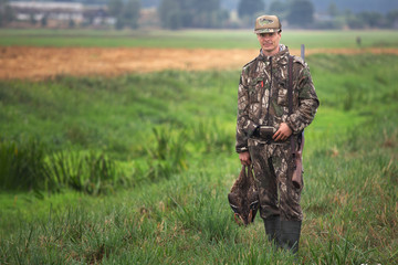 Man hunting ducks in wetlands