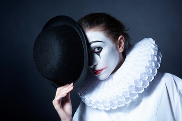 Sad mime Pierrot holding a black hat - obrazy, fototapety, plakaty