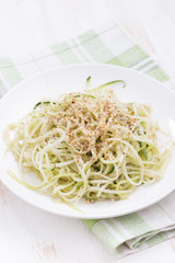 Vegetarian pasta with zucchini and nuts, vertical