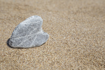 Fototapeta na wymiar heart shaped stone on beach