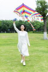 girl flying a kite in the park