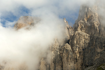 view of a mountain peak through clouds