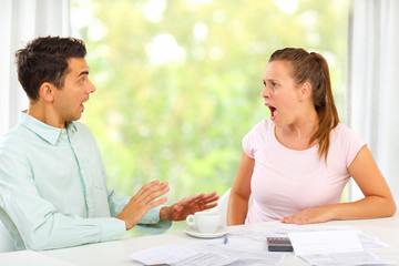 Fototapeta premium Man and woman arguing about home finances