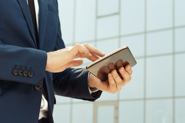 Businessman using a digital tablet outdoors