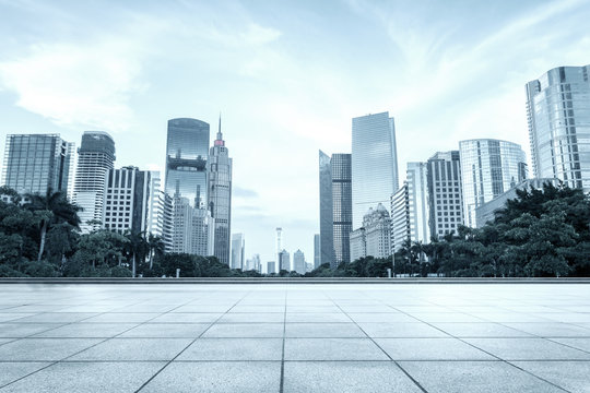 modern square and skyscrapers under cloudy sky