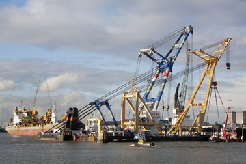 Fototapeta premium Two floating cranes and some ships in Rotterdam harbor