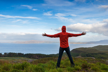 Man jumping on the top pf a mountain, Skye, Scotland