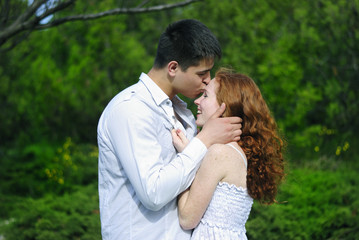 Fototapeta premium beautiful young couple in love on a green glade