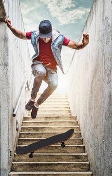Professional skateboarder boy jumps off the stairs