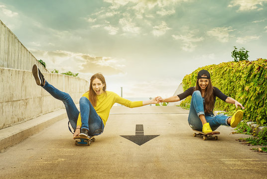 Skateboarder girlfriends roll down the slope
