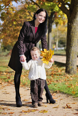 little boy with his mother in autumn park