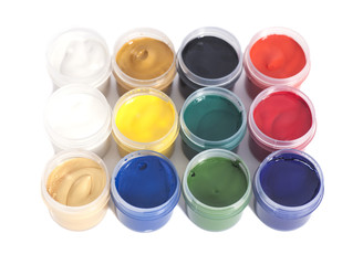 Open colorful cans of gouache paint