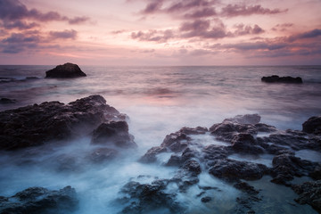 Seashore with misty water at sunset