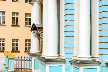 Detail of  facade of the blue  church with white pillars in Russia