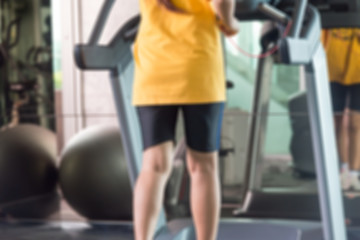 Fototapeta na wymiar Motion blur of woman in yellow shirts and black sport shorts run