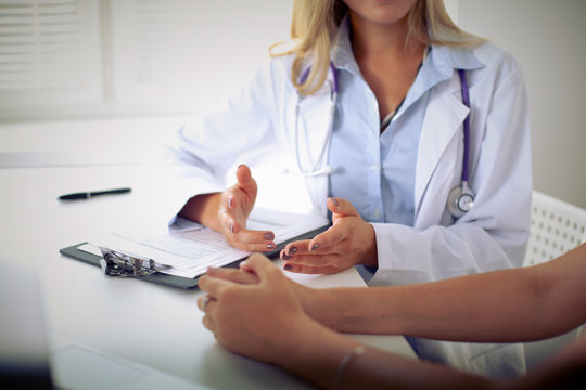Doctor and patient are discussing something, just hands at the table