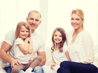 smiling parents and two little girls at new home