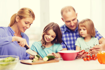 happy family with two kids making dinner at home