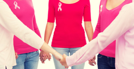 close up of women with cancer awareness ribbons