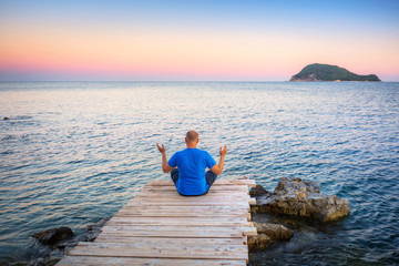 Man watching sunset over ionian sea in Greece