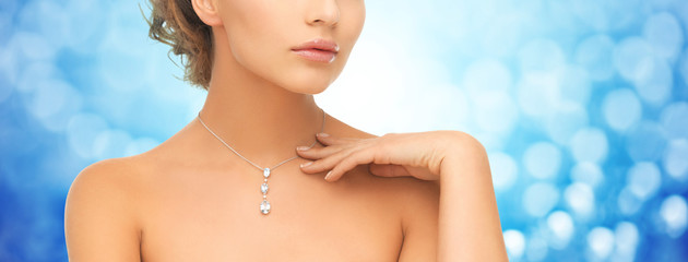 close up of woman wearing shiny diamond pendant