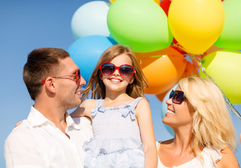 happy family with colorful balloons outdoors