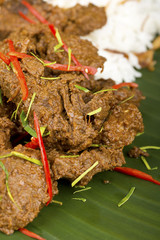 Beef Rendang on Banana Leaf w Steamed Rice in Background. Not sharpened