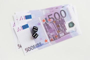 close up of black dice and euro cash money
