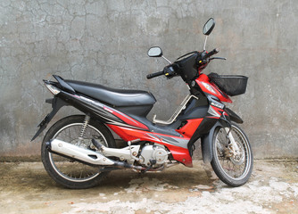 Obraz na płótnie Canvas Motorbike/black and red motorbike on the background of gray wall
