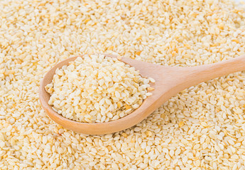 sesame seeds with wooden spoon