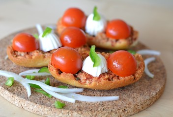 Italian Bruschetta With Mozzarella And Tomato On A Wooden Table