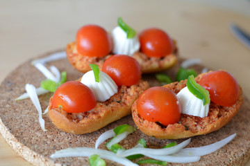Italian Bruschetta With Mozzarella And Tomato On A Wooden Table