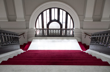 Red carpet on stairs with modern window