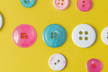 Colorful sewing button on yellow