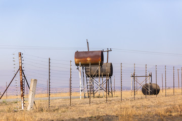 Fototapeta na wymiar Fuel Tanks Rural abandoned deserted gas station landscape