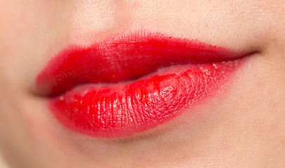 Obraz premium Close-up shot of woman lips with glossy red lipstick