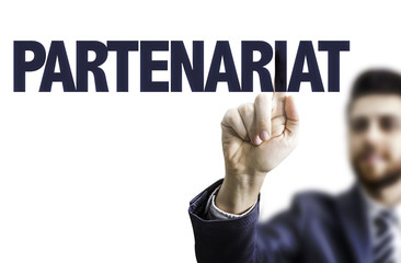 Business man pointing the text: Partnership (in French)